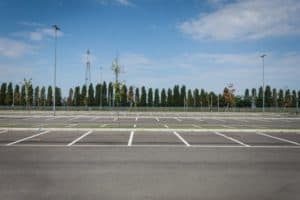 Empty parking lot with trees in the distance