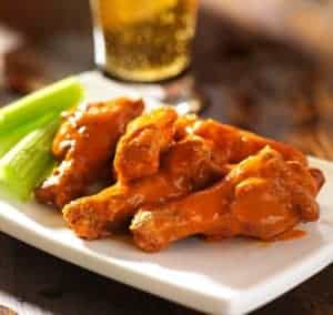 Buffalo wings on a dish with celery