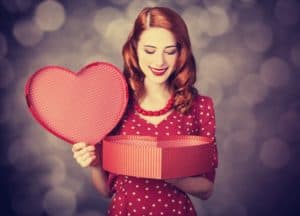 Woman opening a heart shaped box for Valentine's Day
