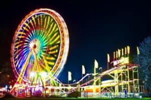 Ferris wheel and roller coaster in an amusement park at night