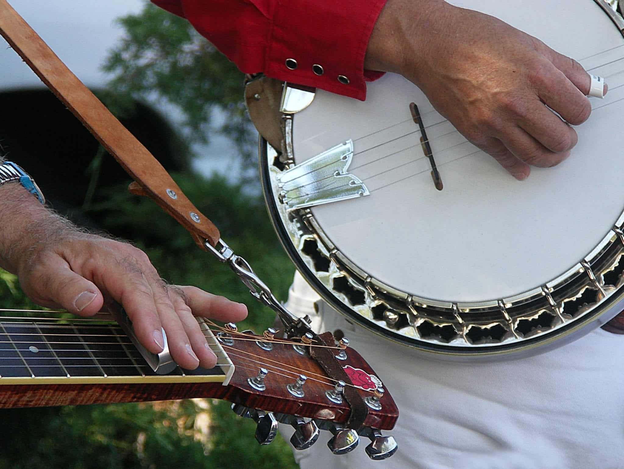Hands plucking banjos