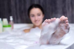 Woman puts her feet up in her Pigeon Forge hotel room with a Jacuzzi