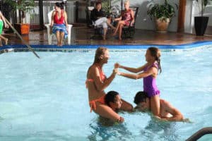 Kids playing chicken in the hotel pool,
