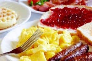 Eggs, sausage, toast, and other breakfast items.