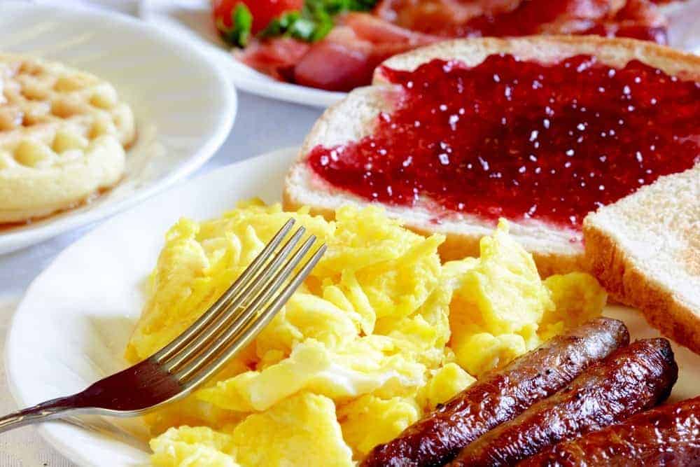 Eggs, sausage, toast, and other breakfast items.