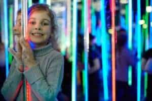 light girl smiling in a mirror maze
