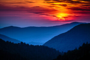sun sets over smoky mountains