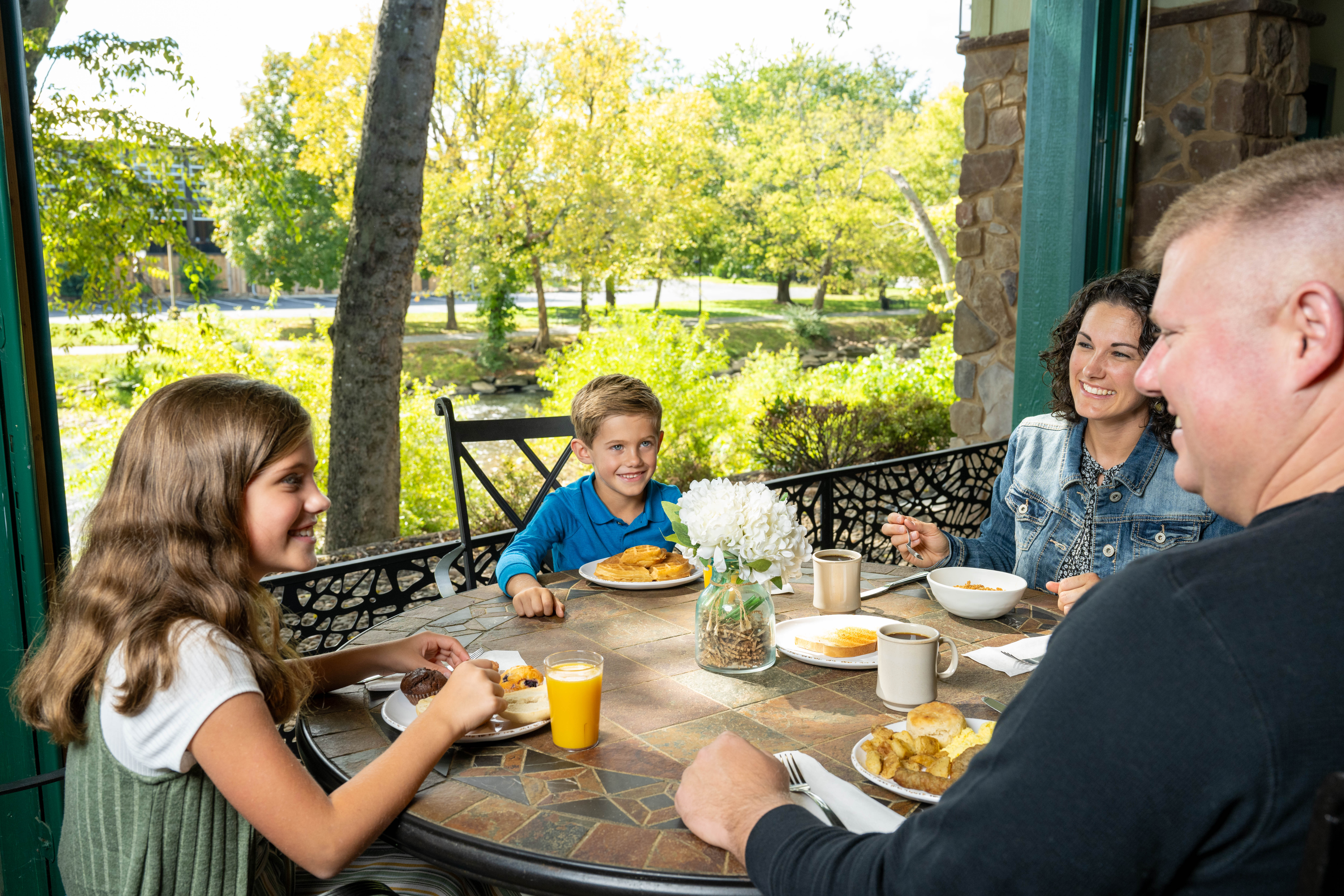 Family enjoying breakfast on outdoor patio