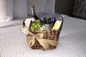 gift basket on bed at the Inn on the River