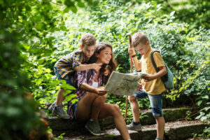 mom and two sons looking at map while hiking in the Great Smoky Mountains